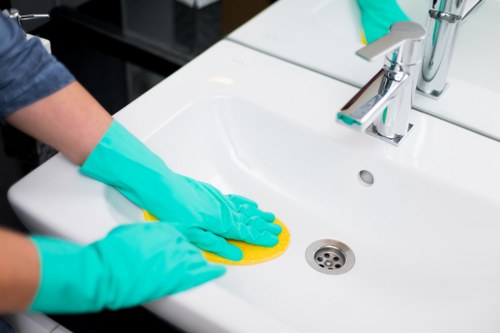 Trusted cleaner in Lambeth cleaning a bright office workspace