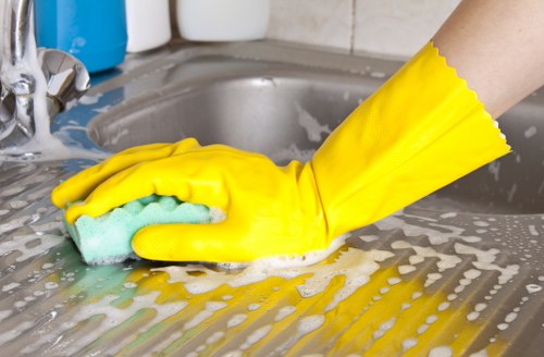 Lambeth cleaner wearing PPE while carrying out safe cleaning procedures