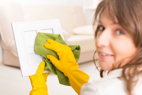 Staff following safe cleaning procedures in a work area